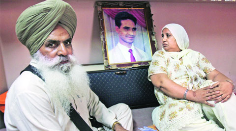 Charanjit Kaur and Amrik Singh with picture of their son Avtar Singh, who was allegedly killed by Gurmeet Pinky