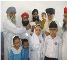 Satnam Singh's family receiving a cheque